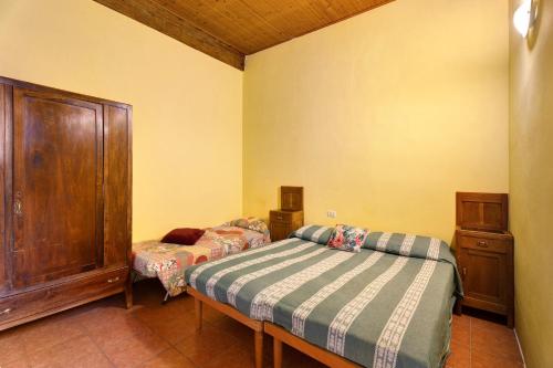 a bedroom with two beds and a dresser in it at Quadrifoglio House in Ameno