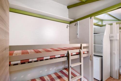 a room with two bunk beds and a closet at chalet nel bosco in Casarza Ligure