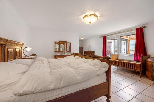 a large white bed in a room with a window at Fewo Moseljuwel mit Sauna und Pool in Traben-Trarbach
