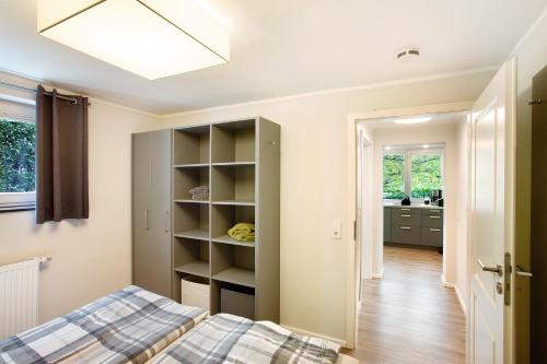 a bedroom with a bed and a closet at Ferienwohnung im Eichholz in Arnsberg