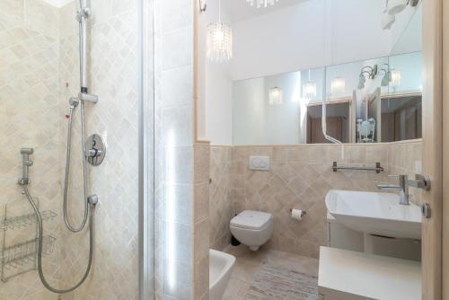 a bathroom with a shower and a toilet and a sink at B 104 Puntavilla Mare in La Maddalena