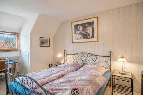 a bedroom with a bed and two tables with lamps at Familienwohnung Haus 18 in Überlingen