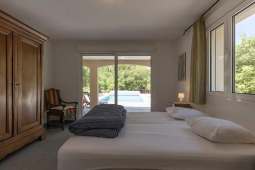 a bedroom with a bed with two pillows on it at Villa La Barbière in Sallelles