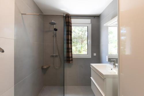 a bathroom with a shower and a sink at Villa La Barbière in Sallelles