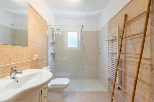 a bathroom with a sink and a shower and a toilet at El Refugio - Quite and Spacious in Benissa