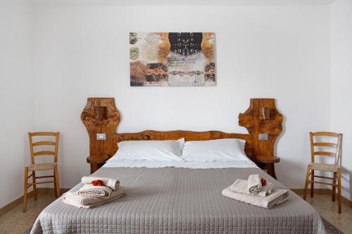 ein Schlafzimmer mit einem Bett, auf dem Handtücher liegen in der Unterkunft Pin e cele in Dronero