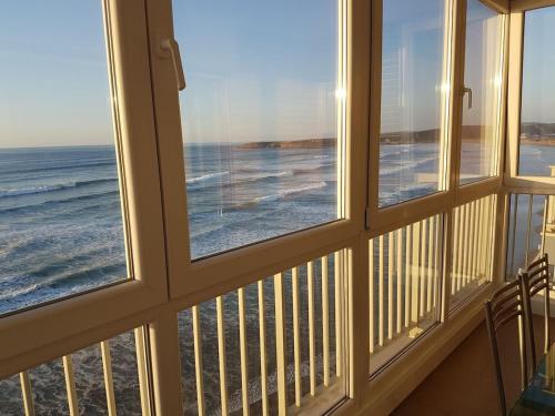 a view of the ocean from a room with windows at Piso en el Mar in Salinas
