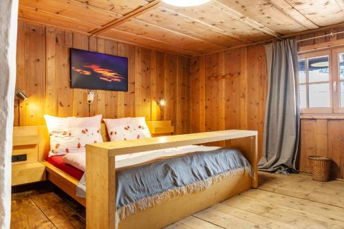 a bedroom with a bed in a wooden room at Liberty Ranch Marlstein in Oetz