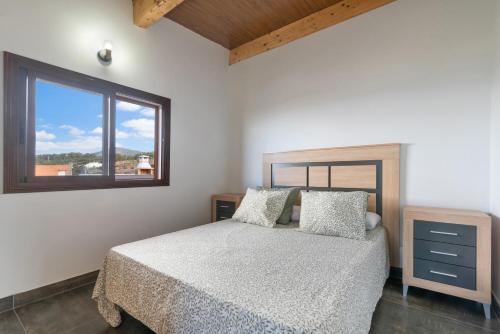 a bedroom with a bed and a window at Vv El Mirador in El Palmital