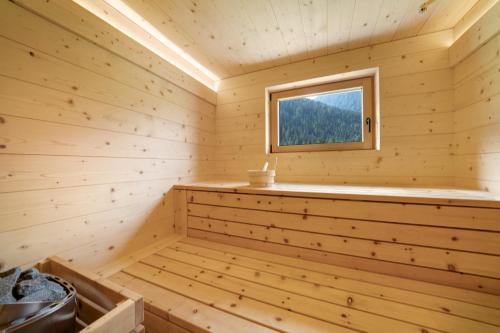 a wooden tub in a log cabin with a window at Masi Rosmarin in Santa Valpurga
