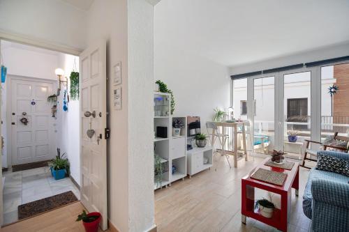 a living room with a blue couch and a table at Apartamento Caepionis in Chipiona