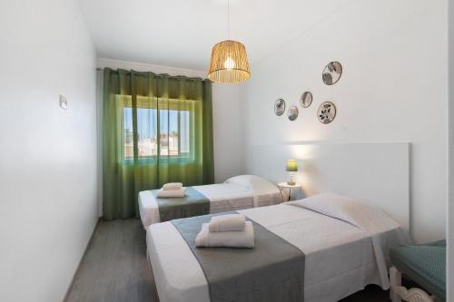 a hospital room with two beds and a window at Justo's House in Faro