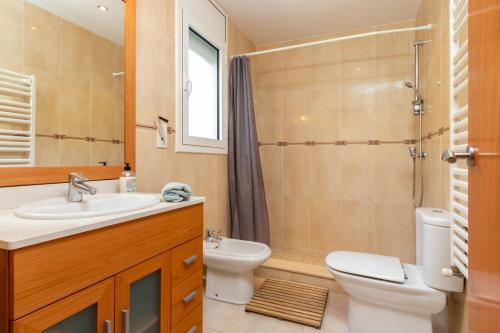 a bathroom with a sink and a toilet and a shower at Villa Elodia in Calonge