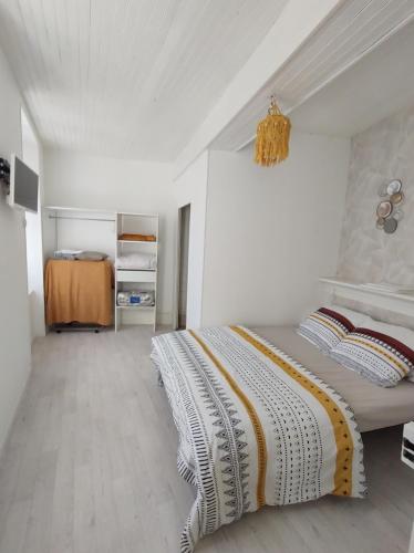 a bedroom with a bed and a chandelier at Séjour familial au Gite Iza – Lorme in Lormes