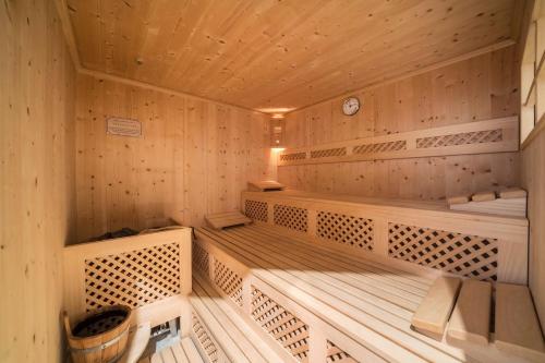 a wooden sauna with benches and a clock at Ferienhaus Maria Edelweiss in Moso