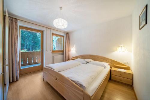 a bedroom with a bed and a large window at Ferienhaus Maria Edelweiss in Moso