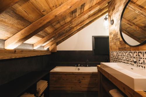a bathroom with a sink and a mirror at Gîte Maria in La Tour