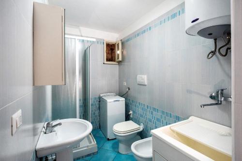 a bathroom with a white toilet and a sink at Ce Tour - Casa Cetara Centro in Cetara