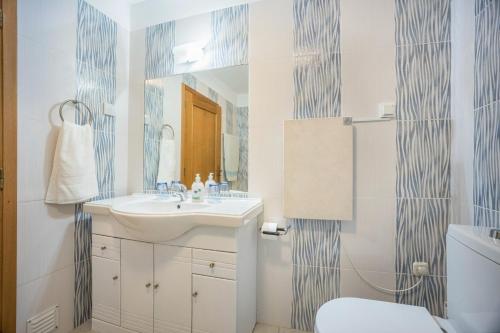 a bathroom with a sink and a mirror at Casa Da Paz in Salema