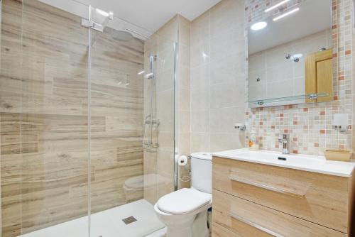 a bathroom with a shower and a toilet and a sink at Casa Pera in Xilxes