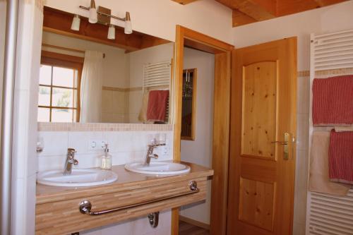 a bathroom with two sinks and a mirror at Urbanshof Herr Tobias Fehrenbach in Hinterzarten