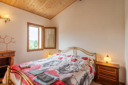 a bedroom with a bed and a window and a dresser at Villetta Allegra in Prataccio