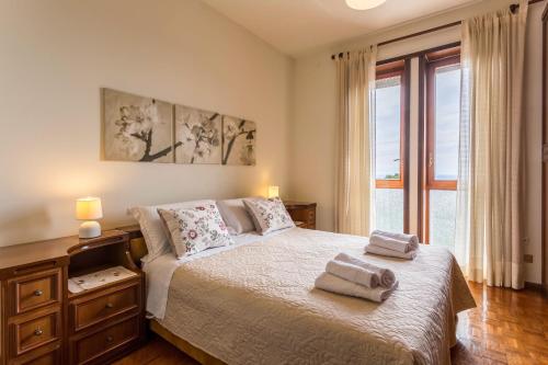 a bedroom with a bed with two towels on it at Attico Panoramico in Brunate