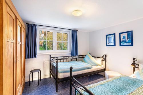 a bedroom with two beds and a window at Haus Lindenfürst in Olsberg