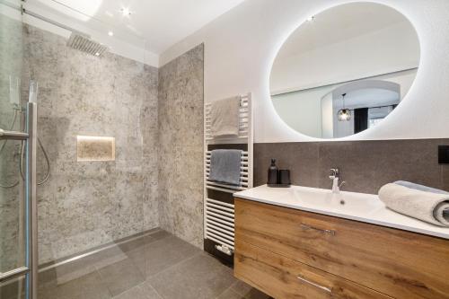 a bathroom with a sink and a mirror at Appartment Riffl Anna in Rifiano