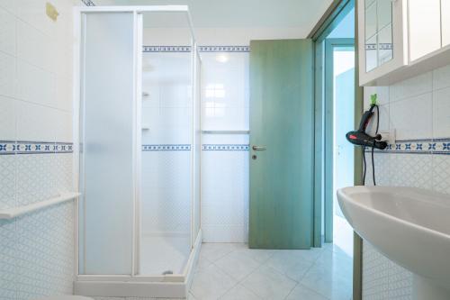 a bathroom with a shower and a sink at Residenza del Sole 1 in Villasimius