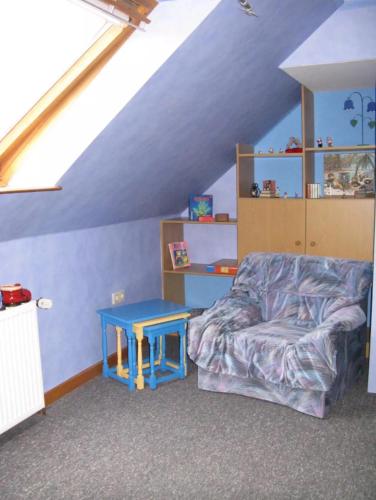 a living room with a couch and a blue table at Ferienhaus Ockholm in Ockholm