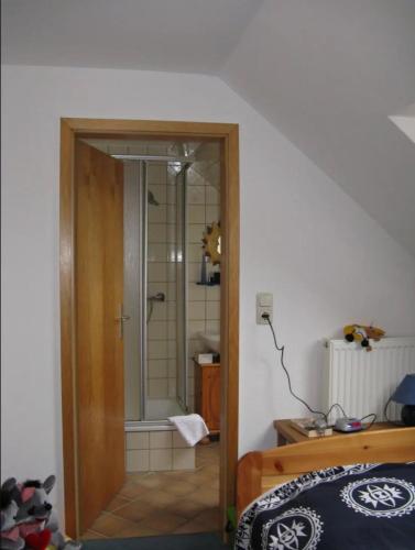 a bathroom with a shower with a glass door at Ferienhaus Ockholm in Ockholm