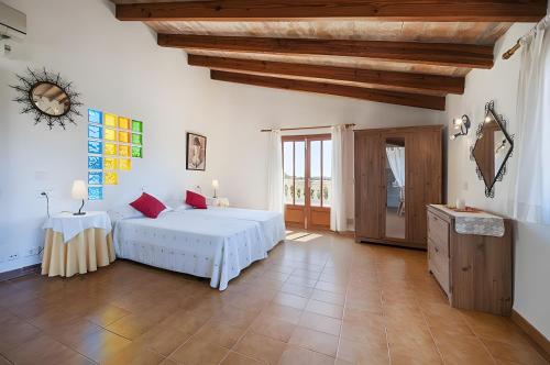 a bedroom with a bed and a wooden ceiling at Can Toni in El Port