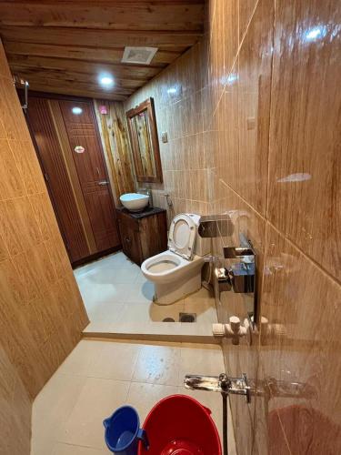 a bathroom with a toilet and a sink at Bonomali Mangrove Resort in Dhāngmāri Forest Office