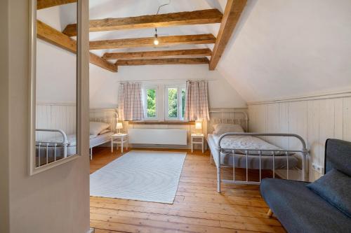a attic room with two beds and a window at Grüner-Seppel in Rodalben
