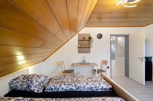 a bedroom with a bed and a wooden ceiling at Ferienwohnung Storchenblick in Grebendorf