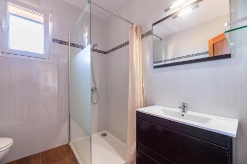 a bathroom with a sink and a shower at Es Camp in Cala Saona