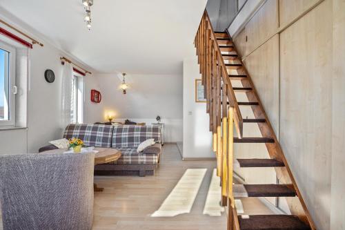 a living room with a staircase and a couch at Haus Arvert in Koserow