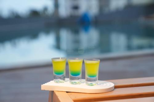 two glasses of orange and green juice on a tray at Athena Premium Suites in Erdemli