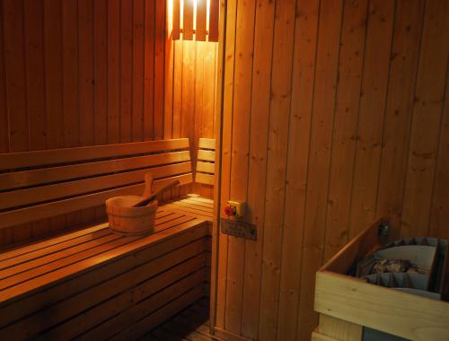 a wooden sauna with a tub and a bucket at Harbour Plaza 8 Degrees in Hong Kong