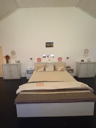 a bedroom with a large bed with two night stands at Villa Maria in Cap Skirring