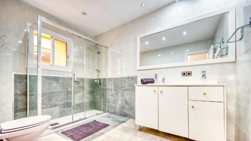 a bathroom with a shower and a toilet and a sink at Costacabana - Villa Sarai in Lloret de Mar