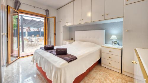 a bedroom with a large bed and a balcony at Costacabana - Villa Sarai in Lloret de Mar