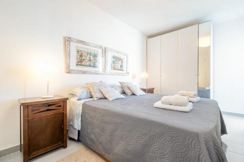 a bedroom with a large bed with two towels on it at Taiko in Port de Pollensa