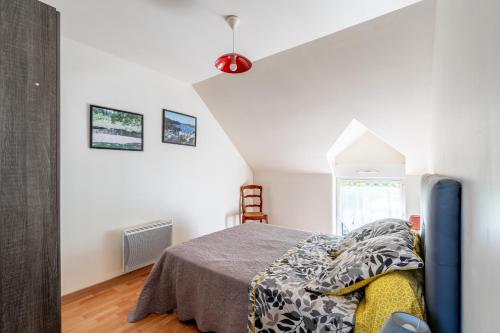 a bedroom with a bed with a gray blanket at Maison de vacances 4 pers in Saint-Just