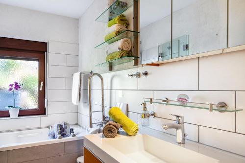 a bathroom with a sink and a mirror at Ferienwohnung Efzeglück mit Pool in Homberg