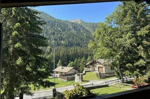 a view of a mountain from a window of a house at Chalet Soleada with Fireplace and Terrace for 5 - Happy Rentals in Pian San Giacomo
