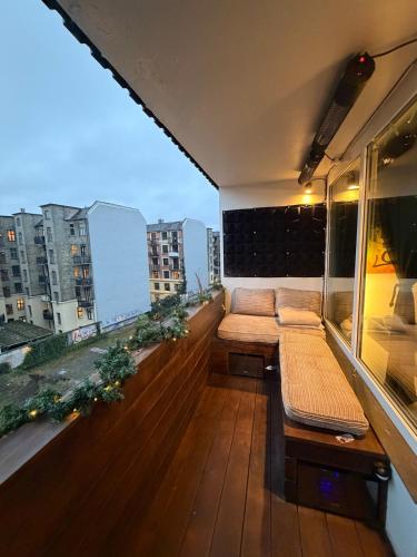 a balcony with a bench and a view of a city at Design Apartment in Vesterbro with Large Balcony in Copenhagen