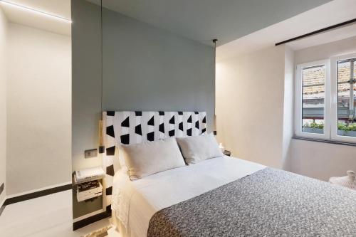 a bedroom with a bed and a window at Torri e tramonti in Albenga