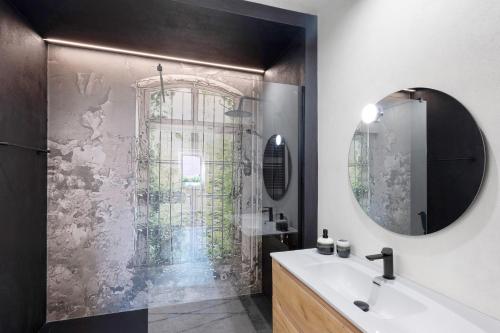 a bathroom with a shower with a sink and a mirror at Torri e tramonti in Albenga